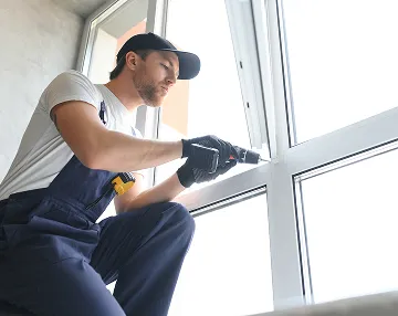 construction-worker-installing-window-house
